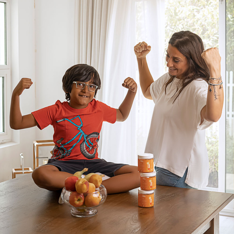 A mother and her son seated at a table, exploring ways to enhance kids' immune defense.