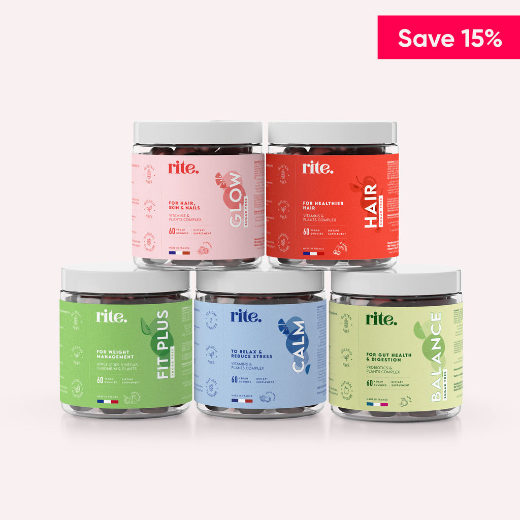 A display of five flavors jars of Rite Gummy vitamins on a table.The flavors visible in the image are "FIT PLUS," "GLOW," "CALM," "HAIR," and "BALANCE."