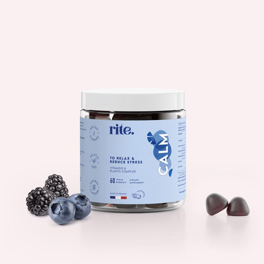 CALM GUMMIES made with vitamins and plant extracts to relax & reduce stress, shown with blackberries and blueberries.