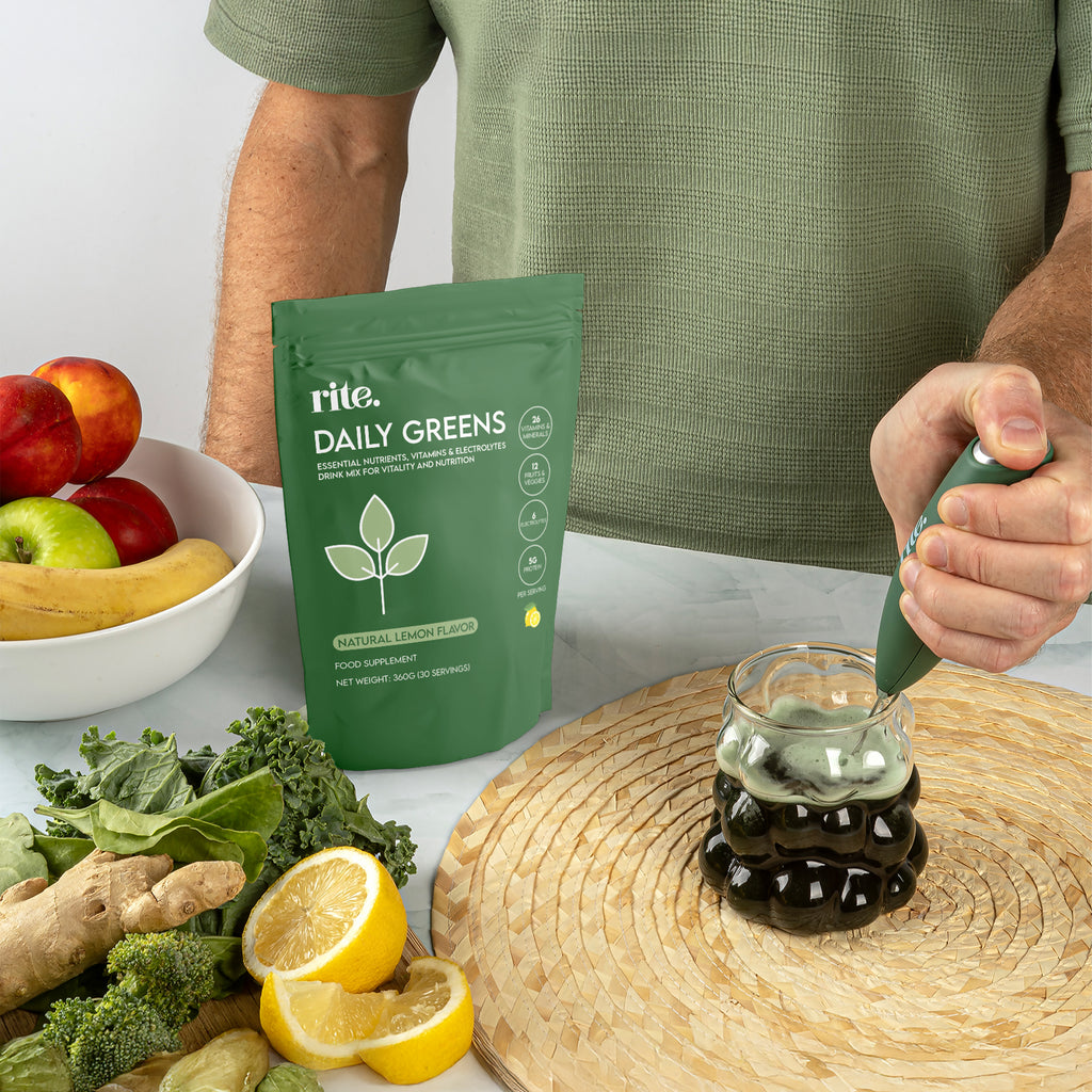 DAILY GREENS supplement powder being mixed in a glass, packed with vitamins, electrolytes, and nutrients for all-day wellness