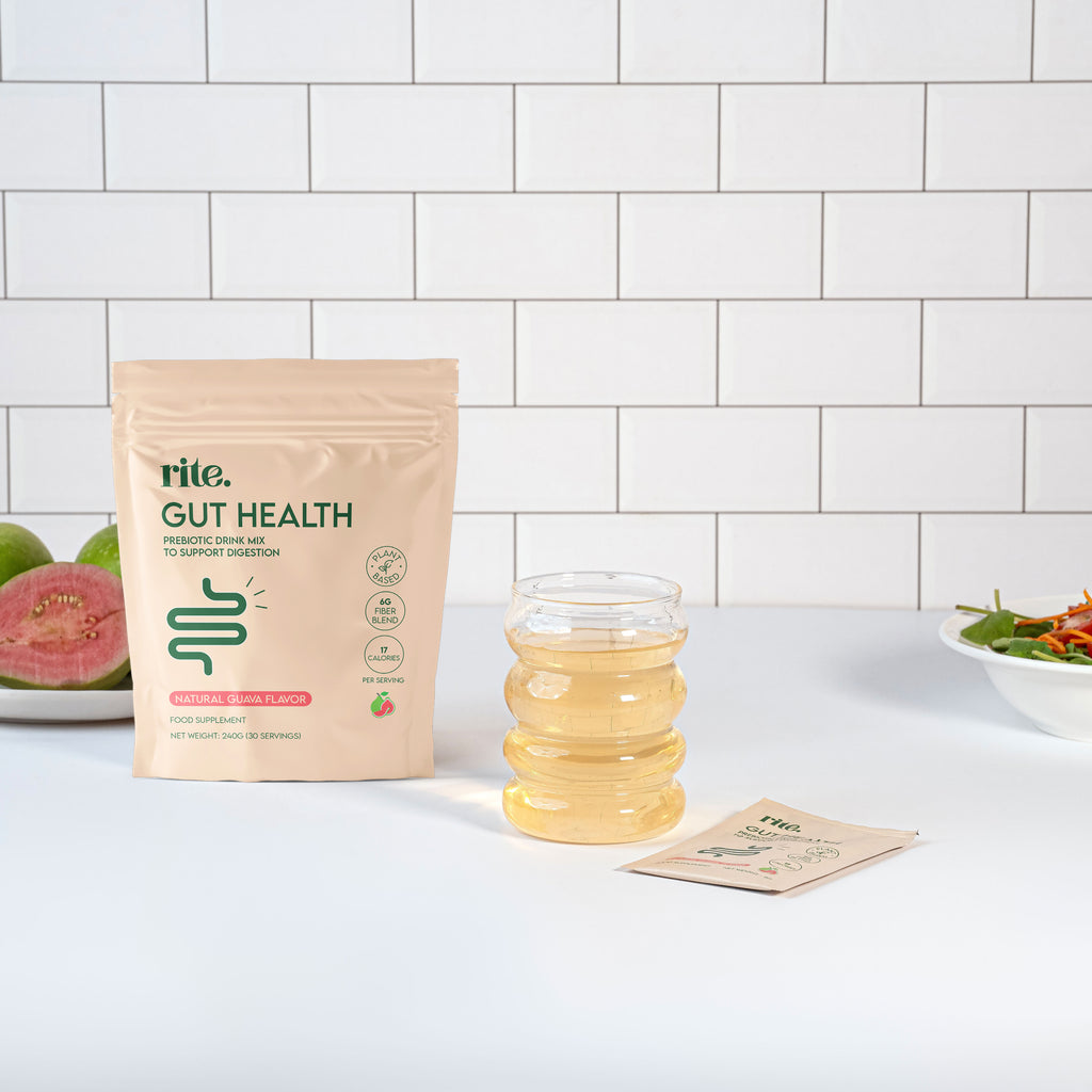 GUT HEALTH prebiotic powder with glass of guava drink to support digestion and gut wellness