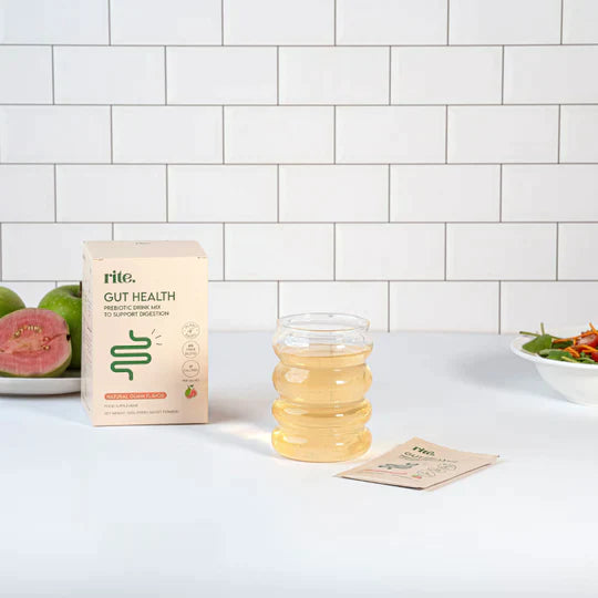 GUT HEALTH prebiotic powder with glass of guava drink to support digestion and gut wellness
