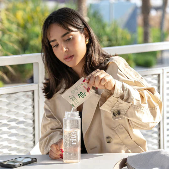 Mixing GUT HEALTH sachet into bottle to support digestion, improve gut health, and boost wellness