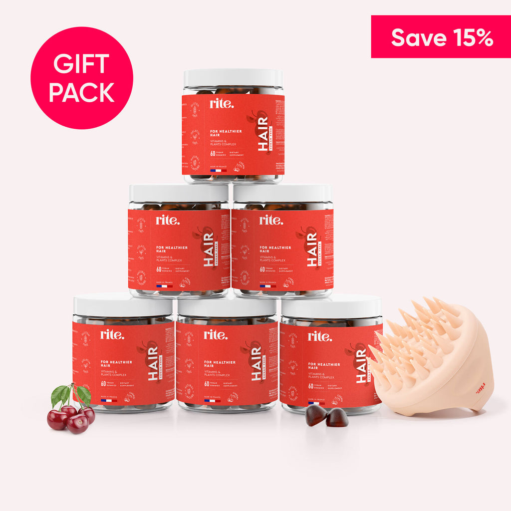 A gift pack containing six Rite Hair gummy vitamin jars and a hair brush on a white background. Text on the box says "Save 15%” and "Gift Pack".