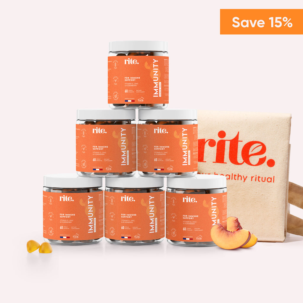 Six jars of Rite Immunity Gummies stacked on top of each other with  slices of peach in front of them.