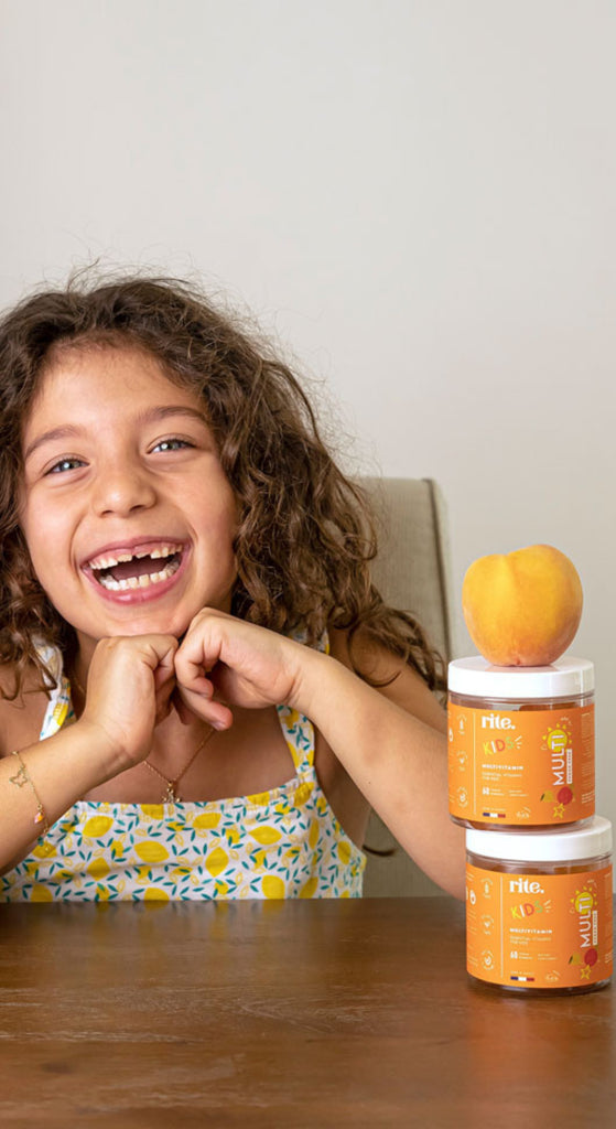 KIDS GUMMIES  jar with orange label promoting multivitamin, immunity, and energy benefits for kids