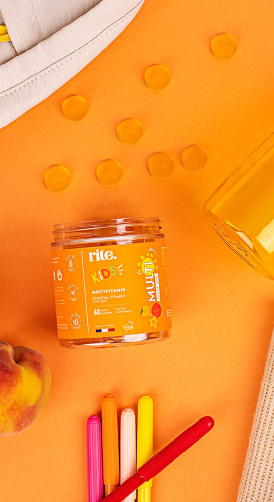KIDS MULTIVITAMIN GUMMIES  jar with orange label promoting multivitamin, immunity, and energy benefits for kids