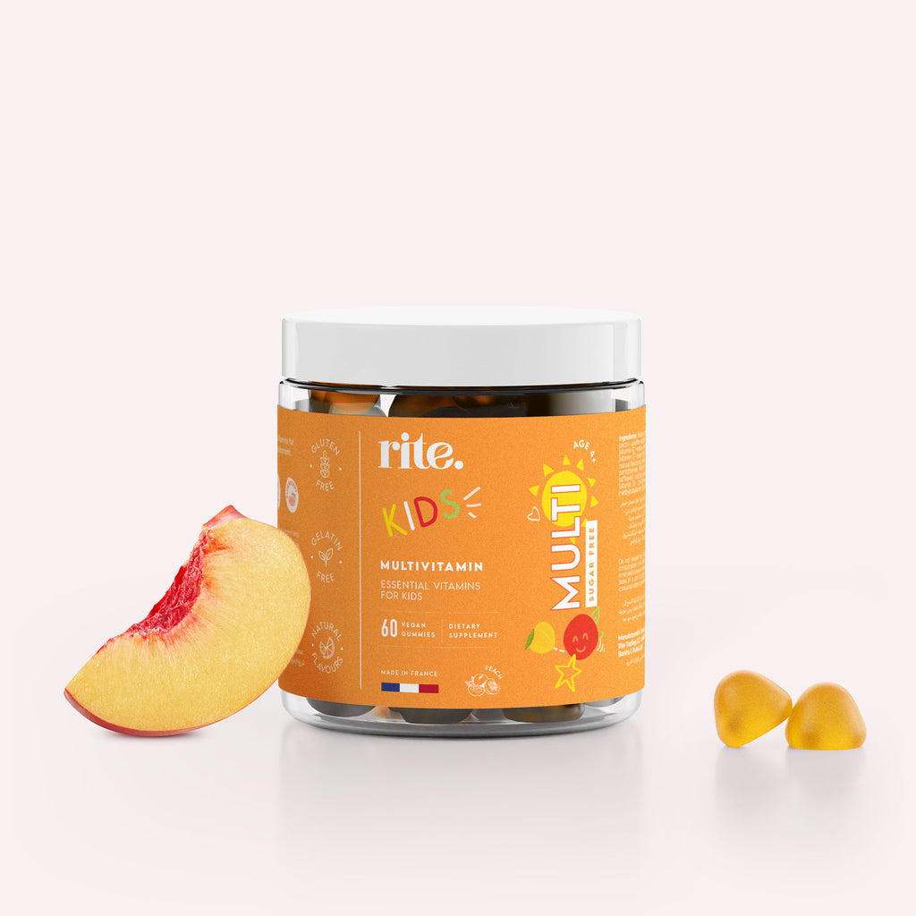 KIDS MULTIVITAMIN GUMMIES with peach flavor, essential vitamins for children, in a clear jar with fruit and gummies.