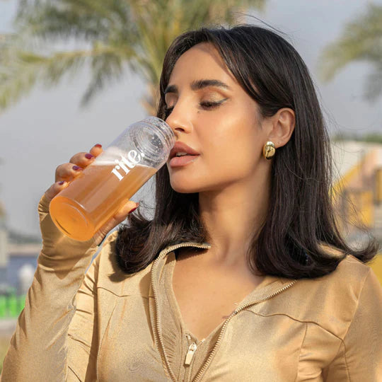 SHAKER BOTTLE filled with orange drink, showcasing portable hydration with stylish transparent design