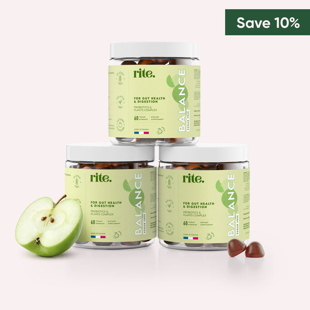 Three jars of Rite Balance Gummy Vitamins stacked on top of each other with  slices of apple in front of them. 