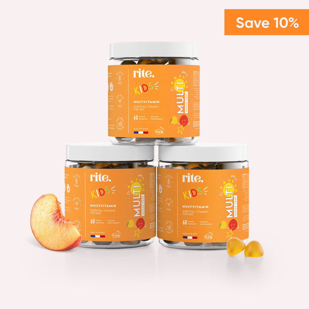 "Three jars of Rite KIDS Multivitamin Sugar Free Gummies stacked on top of each other with slices of peach in front of them. "