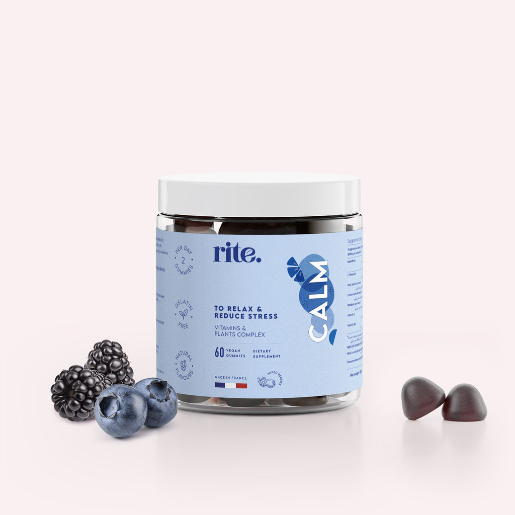 A jar of Rite Calm Gummy Vitamins next  to a blackberry on a white background. 