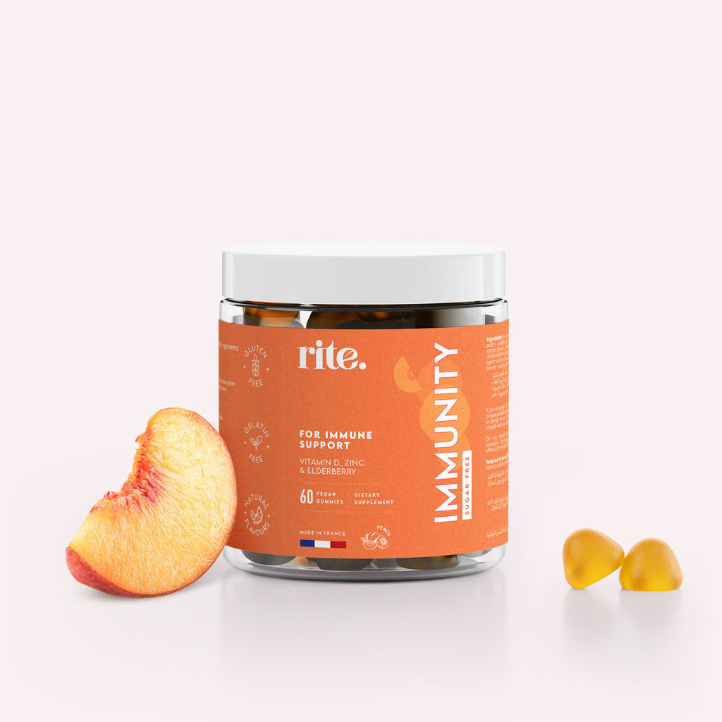 A jar of Rite Immunity Gummies sits next to a sliced peach.
