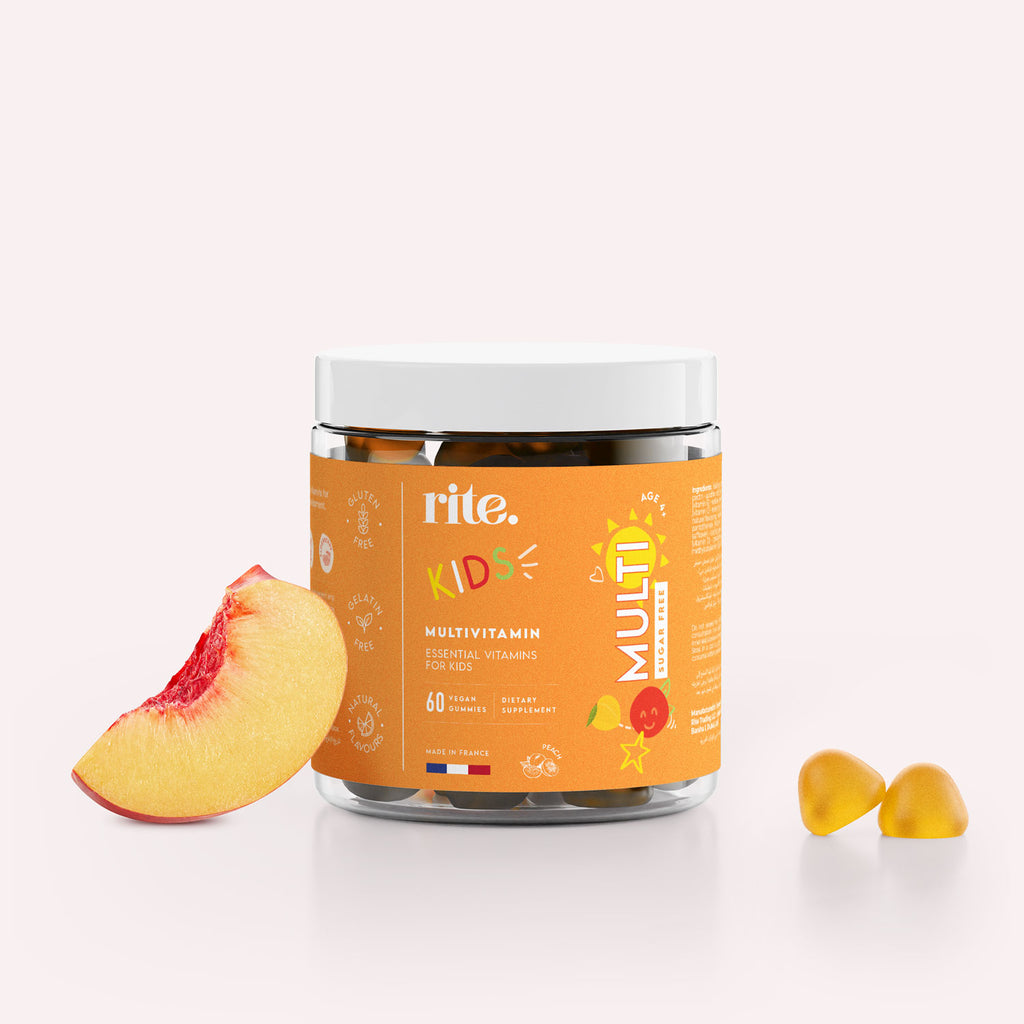 A jar of Rite Multivitamin Sugar Free Gummy Vitamins for KIDS sits next to a sliced peach.
