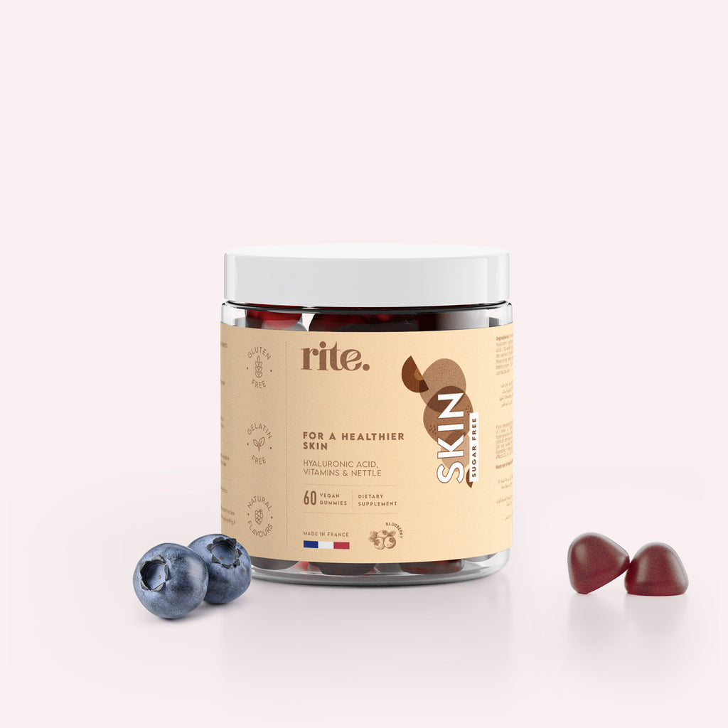 SKIN vitamin gummies bottle with two gummies and fresh blueberries, promoting healthy skin with hyaluronic acid, vitamins, and nettle.