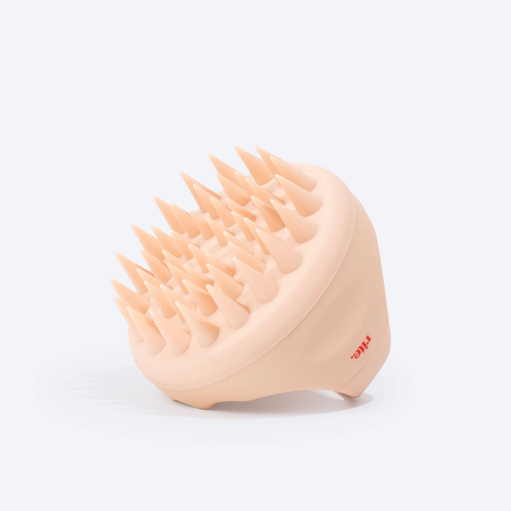 An image of a hair brush with spiked bristles, perfect for scalp massage.